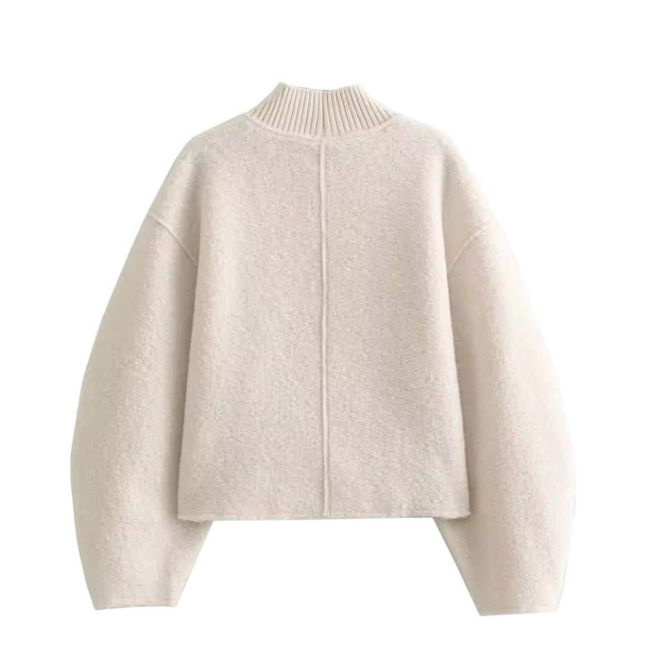 Cream white teddy knit balloon sleeve mock neck cropped fleece pullover for women featuring plush sherpa style fleece texture, chunky knit construction, ribbed mock neckline, oversized balloon sleeves and relaxed fit. Cozy off white and beige winter pullover ideal for UGGs outfits, Scandinavian Stockholm style, apres ski, snow trips, everyday casual and chic cold weather fashion. Ships worldwide.