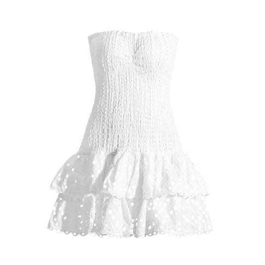 White eyelet embroidered floral anglaise strapless smocked mini dress with layered ruffle trim and tiered flared skirt. Slim fit bodycon corset bustier silhouette with ruched shirred detailing. Chic summer sundress for womens teens ladies perfect for party dress prom hoco homecoming graduation beach vacation ibiza style boho chic resort wear coastal granddaughter aesthetic loveshackfancy dupe zimmerman dupe.