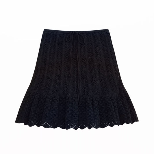 Black eyelet knit crochet ruffle trim high-rise mini skirt for women, teens, and ladies. Knitted embroidered floral and geometric patterned design with slim fit A-line sheath silhouette, scalloped hem, layered ruffles, tiered pleated flared details, and flowy feminine style. Short high-waisted mini skirt perfect for summer 2025 holidays, vacations, beach club, Euro summer, Mediterranean Greece, Ibiza style, boho chic, Stockholm fashion, coastal granddaughter and preppy style. Ideal for casual everyday.