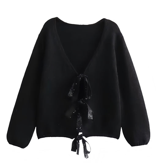 Black Knit Oversized Bow V-Neck Long Sleeve Cropped Cardigan Sweater for women and teens. Soft, cozy, and lightweight knitwear with elegant bow embellishments, relaxed oversized fit, and long sleeves. Trendy coquette, Y2K, and soft girl aesthetic cardigan perfect for fall, winter, and holiday outfits. Feminine, chic, and elegant Scandinavian-inspired sweater. Ships globally and worldwide to the US, UK, Canada, Australia, Europe, and Asia.