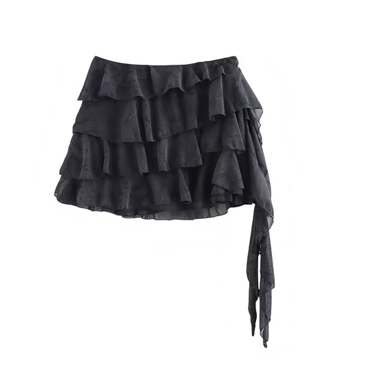 Black layered ruffle trim asymmetric mid-rise mini skirt for women, teens, and ladies. Slim fit A-line slip skirt with shift, sheath, tiered ruffled plissé flared flowy tutu silhouette. Sexy short mini skirt perfect for summer, fall, evening, party, holiday, vacation, club wear, rave, festival, concert, Ibiza style, boho chic, bohemian, Y2K, trendy streetwear, sorority rush. Ships worldwide to USA, UK, Canada, Australia, New Zealand, Germany, France, Italy, Spain, Netherlands, Sweden, Denmark, Europe 