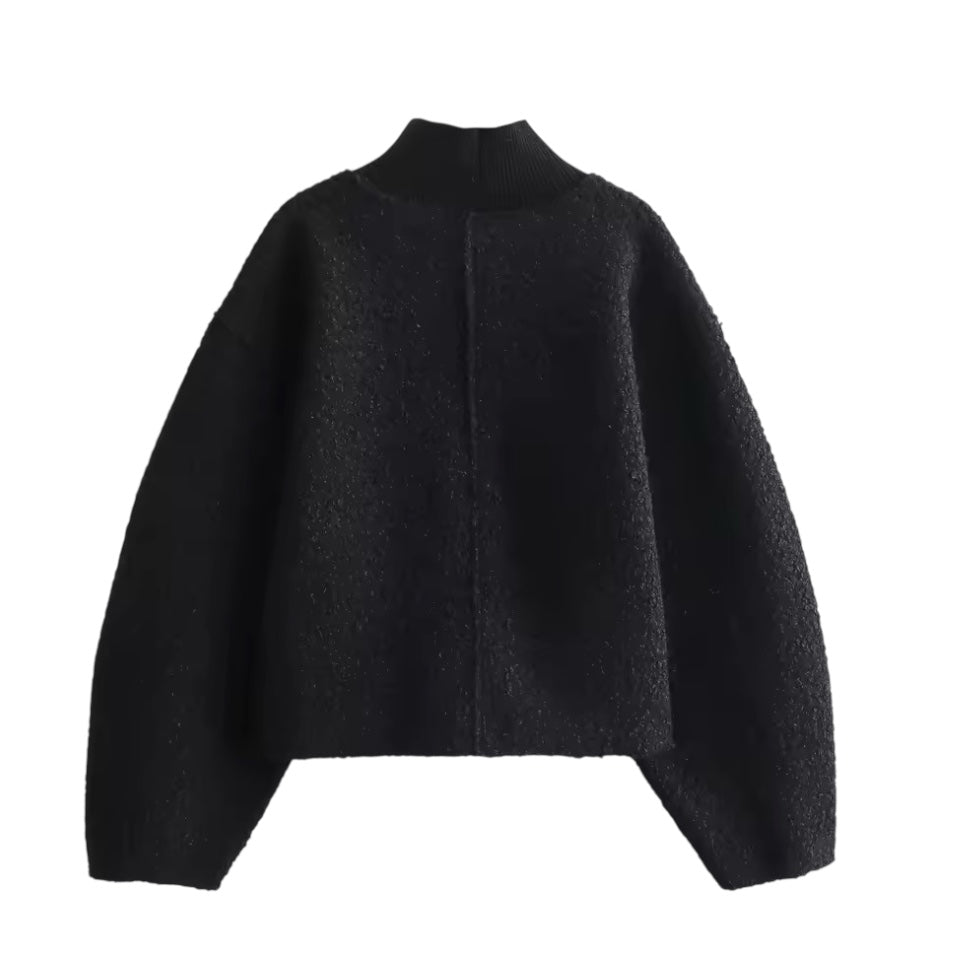Black teddy knit balloon sleeve mock neck cropped fleece pullover for women featuring plush sherpa style fleece texture, chunky knit construction, ribbed mock neckline, oversized balloon sleeves and relaxed fit. Cozy all-black winter pullover ideal for UGGs outfits, Scandinavian Stockholm style, apres ski, snow trips, everyday casual and chic cold weather fashion. Ships worldwide.

