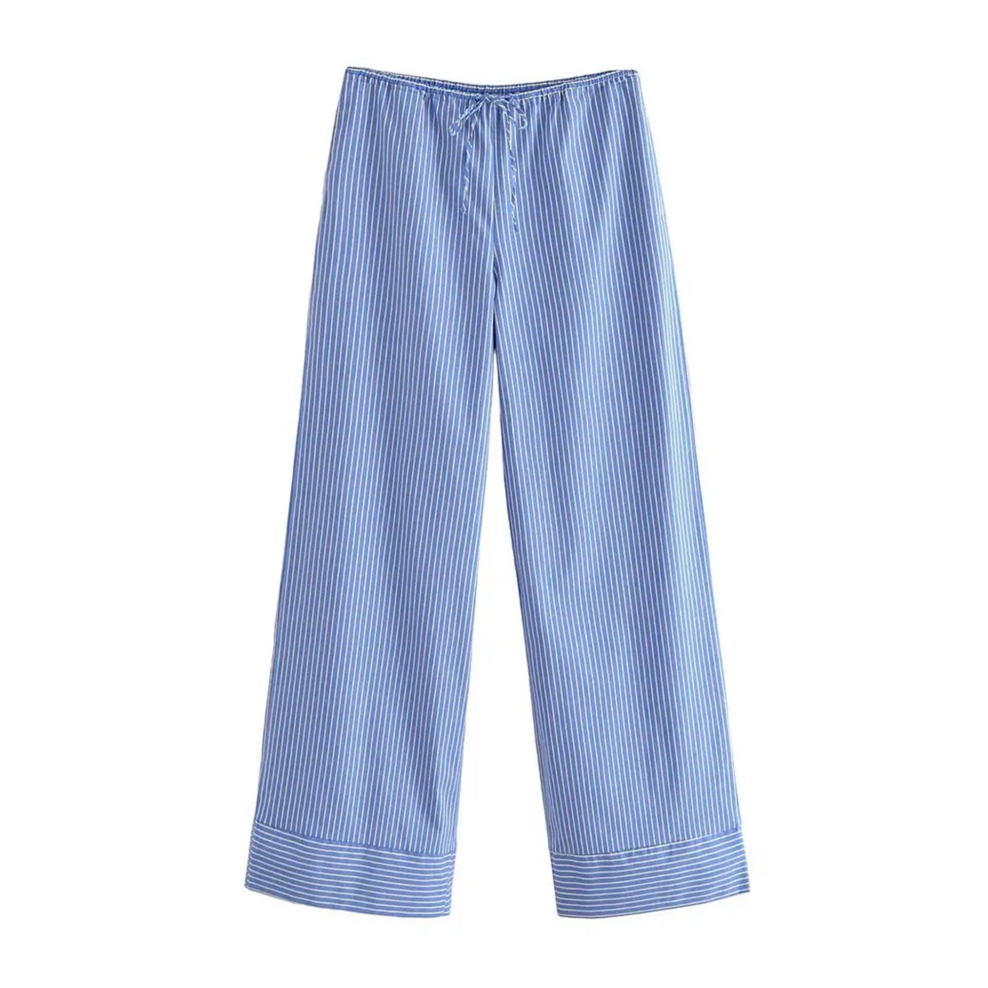 Blue and white striped seersucker low-rise linen pants for women made from soft breathable cotton blend fabric with an adjustable drawstring waistband and relaxed wide-leg fit. Lightweight, comfy, and perfect for resort, travel, or beachwear. Full-length coastal-inspired trousers in nautical pinstripe pattern for everyday or vacation outfits. Ships globally to the US, UK, Canada, Europe, Australia, and Asia.