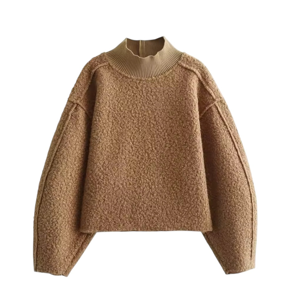 Brown teddy knit balloon sleeve mock neck cropped fleece pullover for women featuring plush sherpa style fleece texture, chunky knit construction, ribbed mock neckline, oversized balloon sleeves and relaxed fit. Cozy camel, caramel and tan toned winter pullover ideal for UGGs outfits, Scandinavian Stockholm style, apres ski, snow trips, everyday casual and chic cold weather fashion. Ships worldwide.