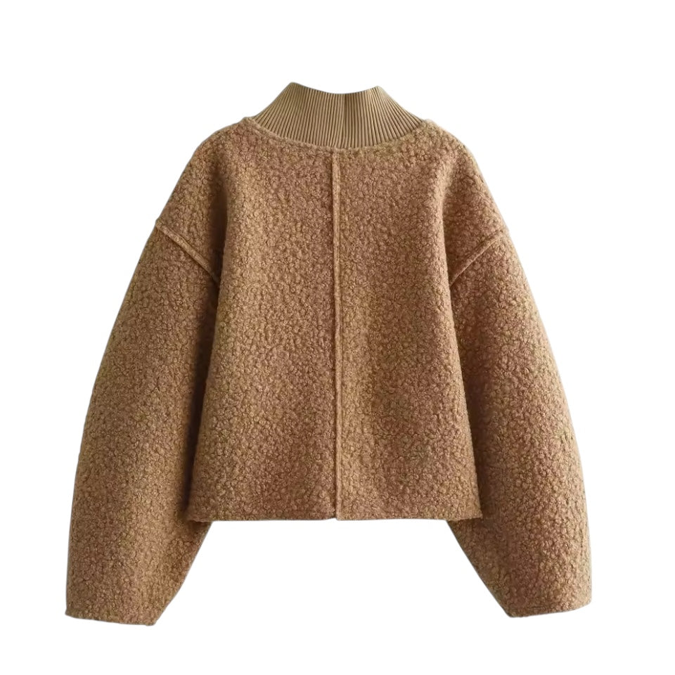 Brown teddy knit balloon sleeve mock neck cropped fleece pullover for women featuring plush sherpa style fleece texture, chunky knit construction, ribbed mock neckline, oversized balloon sleeves and relaxed fit. Cozy camel, caramel and tan toned winter pullover ideal for UGGs outfits, Scandinavian Stockholm style, apres ski, snow trips, everyday casual and chic cold weather fashion. Ships worldwide.