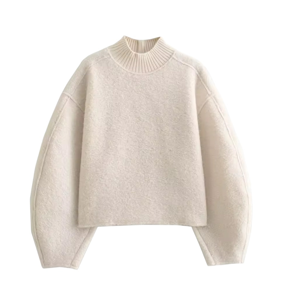 Cream white teddy knit balloon sleeve mock neck cropped fleece pullover for women featuring plush sherpa style fleece texture, chunky knit construction, ribbed mock neckline, oversized balloon sleeves and relaxed fit. Cozy off white and beige winter pullover ideal for UGGs outfits, Scandinavian Stockholm style, apres ski, snow trips, everyday casual and chic cold weather fashion. Ships worldwide.