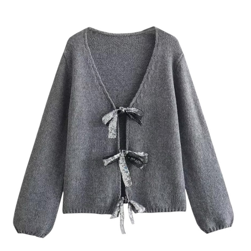 Dark Grey Knit Oversized Bow V-Neck Long Sleeve Cropped Cardigan Sweater for women and teens. Soft, lightweight, cozy knitwear with sparkly bow embellishments and relaxed oversized fit. Elegant and trendy coquette, Y2K, and soft girl aesthetic cardigan perfect for fall, winter, and holiday outfits. Chic Scandinavian-inspired knitwear. Ships globally and worldwide to US, UK, Australia, Canada, Europe, and Asia.