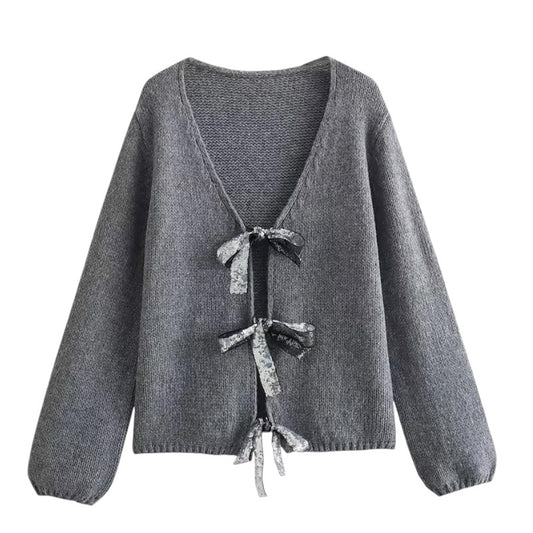 Dark Grey Knit Oversized Bow V-Neck Long Sleeve Cropped Cardigan Sweater for women and teens. Soft, lightweight, cozy knitwear with sparkly bow embellishments and relaxed oversized fit. Elegant and trendy coquette, Y2K, and soft girl aesthetic cardigan perfect for fall, winter, and holiday outfits. Chic Scandinavian-inspired knitwear. Ships globally and worldwide to US, UK, Australia, Canada, Europe, and Asia.