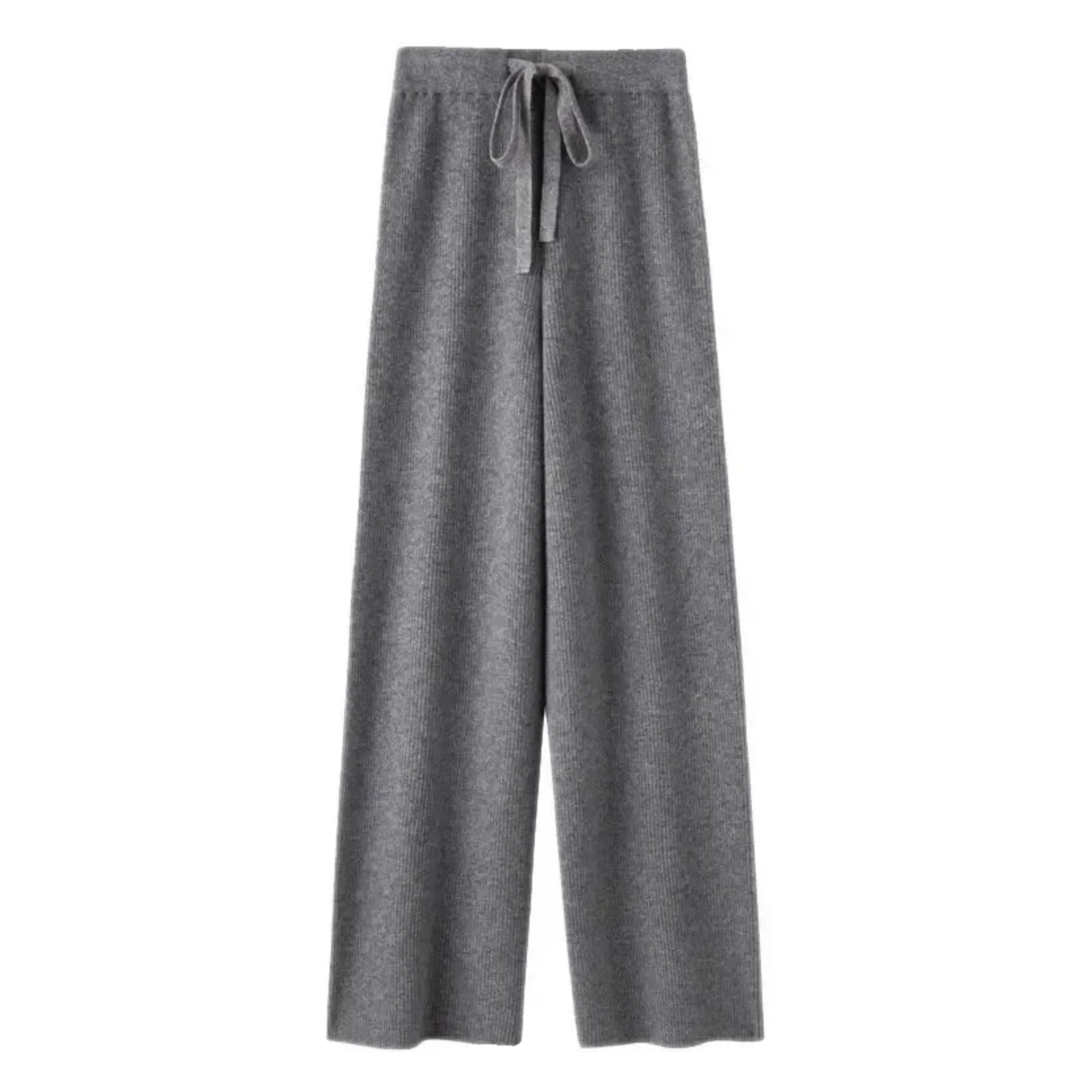 Dark grey knit straight leg mid-rise lounge pants for women made from soft, cozy, and warm knitted fabric. These elevated wool blend trousers feature a relaxed yet structured fit with a full-length silhouette, perfect for everyday comfort or travel. Ideal for minimalist fashion, Scandinavian streetwear, or après-ski looks. Stylish, comfy, and versatile knitwear pants that ship globally and worldwide to the US, UK, Canada, Australia, and Europe.