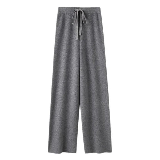 Dark grey knit straight leg mid-rise lounge pants for women made from soft, cozy, and warm knitted fabric. These elevated wool blend trousers feature a relaxed yet structured fit with a full-length silhouette, perfect for everyday comfort or travel. Ideal for minimalist fashion, Scandinavian streetwear, or après-ski looks. Stylish, comfy, and versatile knitwear pants that ship globally and worldwide to the US, UK, Canada, Australia, and Europe.