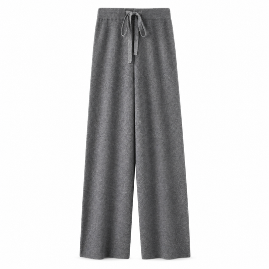 Dark grey charcoal knit wide leg fleece pants for women with soft sweater-knit construction, ribbed fitted drawstring mid-rise waistband, relaxed baggy fit and full-length draped wide legs. Cozy elevated loungewear and knit trousers for fall winter 2026, Scandi, Stockholm, Copenhagen, minimalist, quiet luxury, old money, Parisian, casual chic, preppy, airport, travel, college, streetwear, clean girl, model off duty and everyday outfits.

