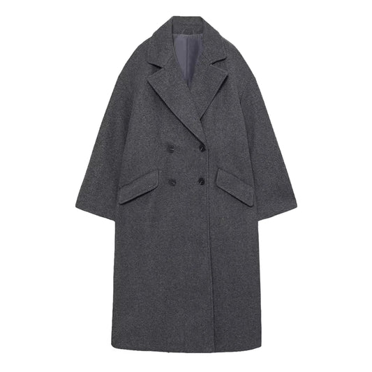 Dark grey woolen oversized trench coat for women with double breasted black buttons, wide lapel collar, long sleeves, structured relaxed tailored fit, front welt pockets, soft insulated wool blend fabric, warm cozy fall and winter coat, elegant minimalist streetwear jacket, neutral old money fashion outerwear, Scandinavian style trench coat shipped worldwide to US, Canada, UK, Australia, Europe, Asia.