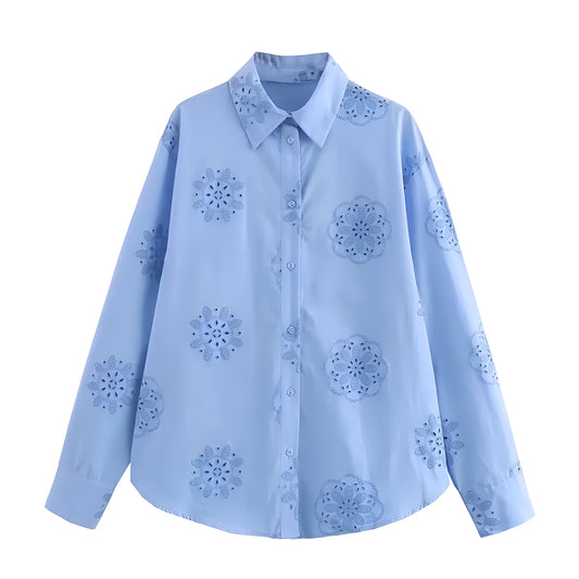 Light blue eyelet embroidered button-down long sleeve linen shirt for women with floral cutout crochet detailing, relaxed oversized fit, v-neck collar, and soft breathable cotton blend fabric. Feminine vacation blouse for coastal granddaughter style, Euro summer, beach club, Greece and Ibiza outfits, boho chic and Scandinavian fashion. Ships worldwide to US, UK, Canada, Australia, Europe, Asia and more.