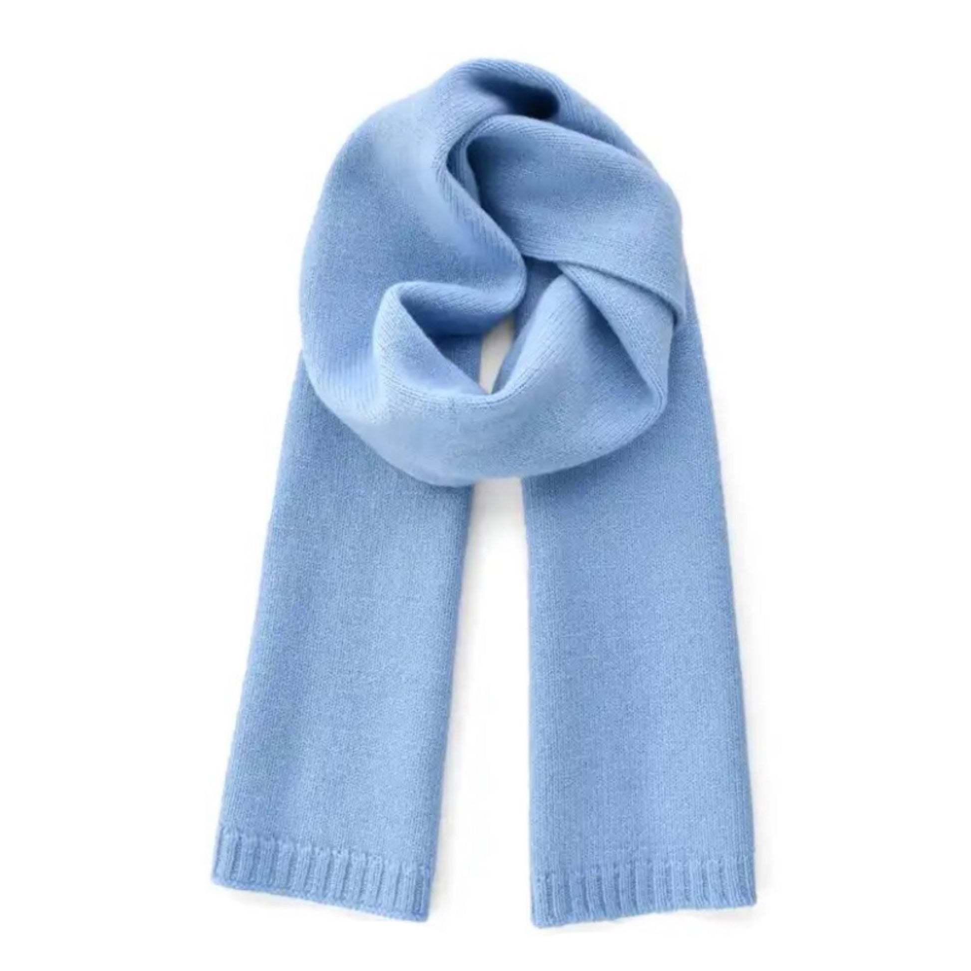 Light blue oversized knit wool scarf for women crafted from a soft plush wool blend yarn. Thick, chunky knit texture with cozy and warm feel, perfect for fall and winter layering. Feminine pastel blue color inspired by Scandinavian street style and minimalist cold-weather fashion. Elegant, versatile, and luxurious knitwear essential. Ships worldwide to US, UK, Canada, Australia, New Zealand, Europe, and Asia.