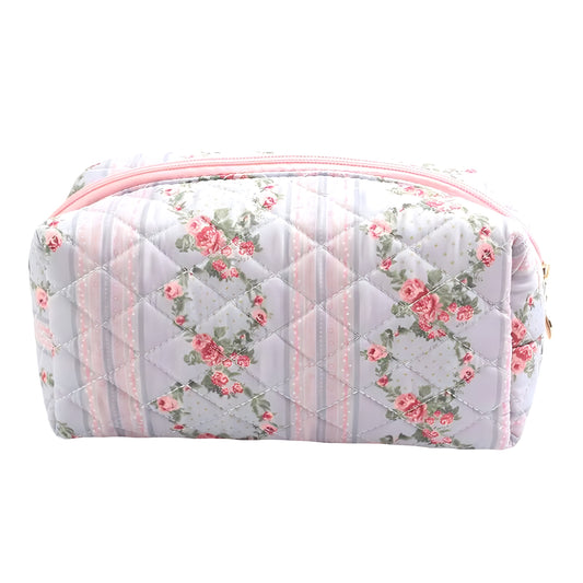 Light blue, light pink, and white rose floral print quilted makeup bag with soft cotton-blend fabric and metallic zipper. Lightweight, vegan-friendly, and durable cosmetic pouch for women and teens. Perfect for storing makeup, skincare, and toiletries while traveling or at home. Feminine coquette and preppy design inspired by LoveshackFancy, Roller Rabbit, and Altard State. Ships worldwide to US, UK, Canada, Australia, New Zealand, Europe, and Asia.