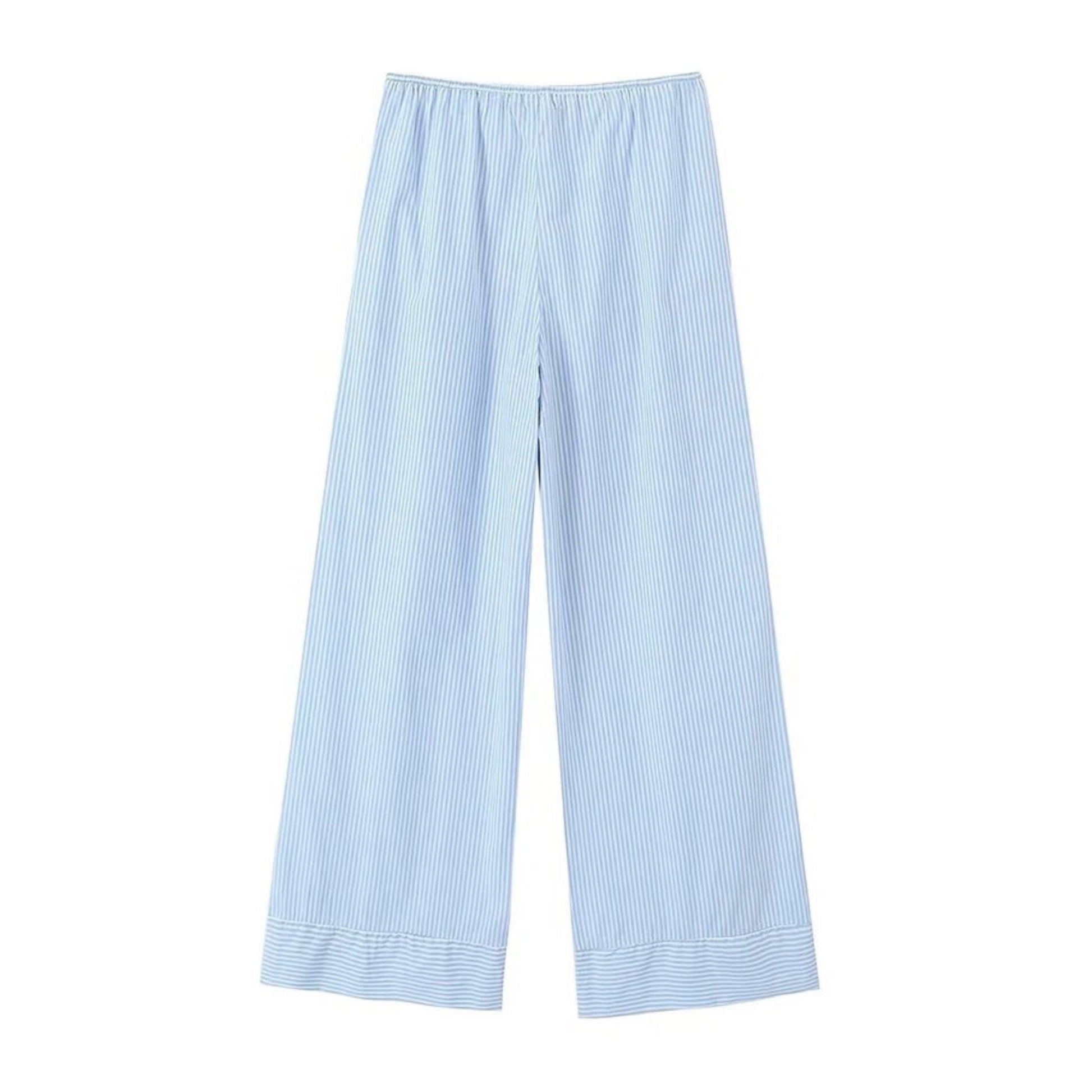 Light blue striped seersucker low-rise linen pants for women with soft breathable cotton blend fabric, adjustable drawstring waistband, and full-length relaxed fit silhouette. Lightweight and comfy coastal resort wear perfect for beach vacations, travel, or casual everyday outfits. Classic nautical pinstripe design in baby blue and white. Ships globally to the US, UK, Canada, Europe, Australia, and Asia.