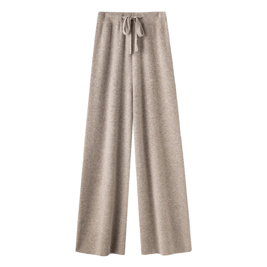 Light brown knit straight leg mid-rise lounge pants for women made from soft, cozy, and thick knitted wool-blend fabric. These elevated knitwear trousers feature a relaxed silhouette and a classic mid-rise waist, ideal for casual or minimalist everyday wear. Perfect for cozy lounge days, streetwear layering, or après-ski outfits. Chic neutral color flatters all skin tones. Ships globally and worldwide to the US, UK, Canada, Australia, and throughout Europe.