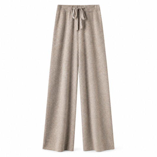 Light brown oatmeal beige knit wide leg fleece pants for women with soft sweater-knit construction, ribbed fitted drawstring mid-rise waistband, relaxed baggy fit and full-length draped wide legs. Warm cozy elevated loungewear and knit trousers for fall winter 2026, neutral, minimalist, quiet luxury, old money, Scandi, Stockholm, Copenhagen, Parisian, preppy, clean girl, casual chic, airport, travel, college and everyday outfits.

