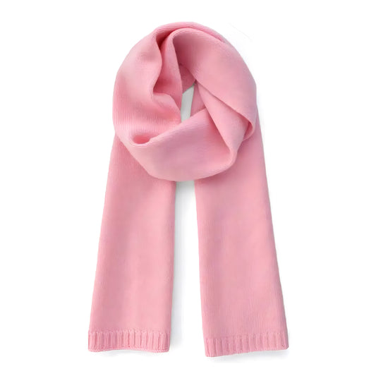 Light pink oversized knit wool scarf for women made from soft, plush wool blend yarn with a thick, chunky knit texture. Warm and cozy pastel pink winter accessory ideal for layering over coats and sweaters. Feminine minimalist design inspired by Scandinavian street style and old-money elegance. Perfect for travel, fall, and winter 2025 fashion. Ships worldwide to US, UK, Canada, Australia, Europe, and Asia.