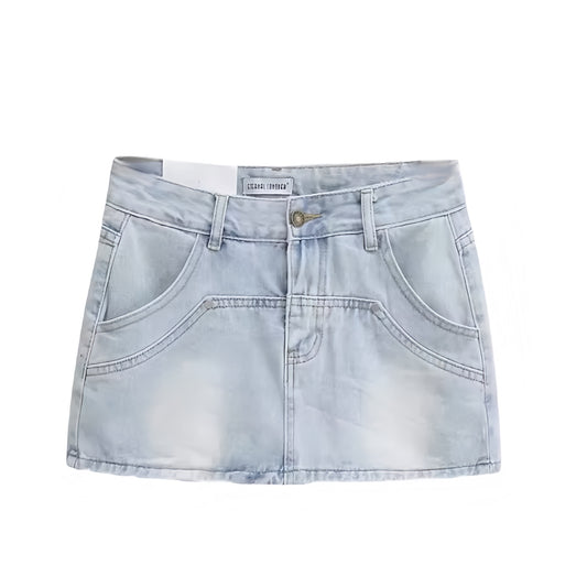 Light wash faded vintage denim mini skirt with studded detail. Low rise slim fit bodycon a line silhouette short jean skirt with pockets. Retro western country girl chic Y2K feminine fashion. Perfect for casual everyday outfits, summer fall street wear, sorority rush, school, party, rave, concert, festival, sexy club wear, trendy boho chic, Stockholm style, and night out looks. Ships globally worldwide to USA, UK, Canada, Australia, New Zealand, Germany, France, Ireland, Denmark, Sweden, Switzerland, Europe
