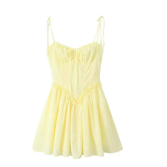 Light yellow butter yellow eyelet floral embroidery milkmaid mini dress with slim fit corset bustier bodice, sweetheart neckline, ruffle trim, sleeveless spaghetti straps, chic backless style, drop waist design, pleated flared skirt. Feminine coquette-inspired sundress for women and teens. Perfect summer vacation dress for brunch, beach, sorority rush, school, prom, hoco, homecoming, graduation, parties, night out, Hamptons and Nantucket chic fashion. Ships worldwide to USA, UK, Canada, Australia, New Zeala