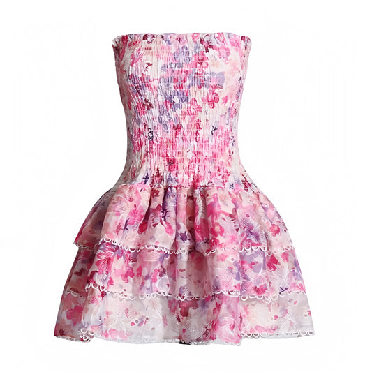 Magnolia floral pink white purple multicolor eyelet embroidered strapless smocked mini dress with layered ruffle trim and tiered flared skirt. Slim fit bodycon corset bustier silhouette with ruched shirred detailing and sweetheart neckline. Chic summer sundress for womens teens ladies perfect for party dress prom hoco homecoming graduation beach vacation ibiza style boho chic resort wear coastal aesthetic euro summer loveshackfancy dupe zimmermann dupe.

