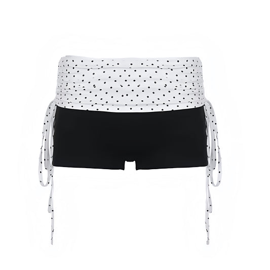 Black and white polka dot slim fold over low-rise micro shorts with dot patterned design, spandex and cotton blend fabric, slim fit bodycon skinny fit silhouette and fold over waistband. Y2K fold over shorts, short shorts, micro shorts, mini shorts and hot pants for women, teens and ladies. Perfect for Y2K style, 2000s fashion, party outfits, night out outfits, club wear, rave shorts, festival outfits, concert outfits, coquette outfits, baddie fits, streetwear, retro style, 2016 Tumblr style, Halloween.