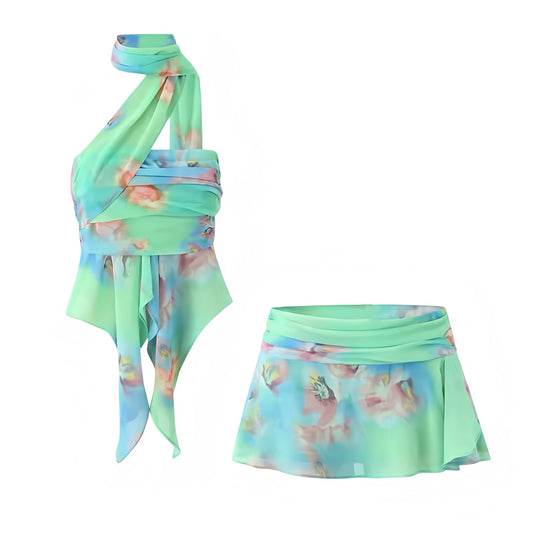 Tiana Multicolor Floral Print Ruffle Trim Halter Top & Low-Rise Mini Skirt 2 Piece Set. Green, blue, pink tropical flower patterned slim fit two-piece set with layered ruffle crop top featuring sleeveless halter neckline, mock neck detail, asymmetric cut, and matching low-rise mini skirt. Flared ruffle trim matching outfit perfect for women, teens, and ladies seeking chic Y2K fashion for holidays, vacations, festivals, parties, night out, sexy club wear, rave looks, Ibiza style, boho chic, Euro summer