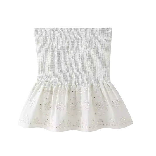 White embroidery sequin embellished boho smocked ruffle trim mini skirt for women, teens, and ladies. Slim fit embroidered linen skirt with floral and geometric crochet patterns, sequin detailing, high-rise drop waist, layered ruffle trim, pleated tiered flared design, and flowy peplum silhouette. Perfect for 2025 summer holidays, vacations, casual everyday fashion, chic coastal granddaughter style, boho chic, Ibiza beachwear, Euro summer, Stockholm fashion, Greece resort wear, vintage retro and western.