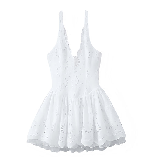 White eyelet embroidered lace trim V-neck drop waist halter mini dress for women and teens. Slim fit corset bustier silhouette with ruffle trim, plissé pleated flared skirt, sleeveless halter neckline, and sexy backless cut. Short embroidered floral patterned sundress, feminine and elegant, perfect for summer holidays, Euro summer, Ibiza boho chic, coastal granddaughter style, preppy Hamptons and Nantucket looks. Ideal for vacation, brunch, graduation, sorority rush, prom, homecoming, formal dances, parties