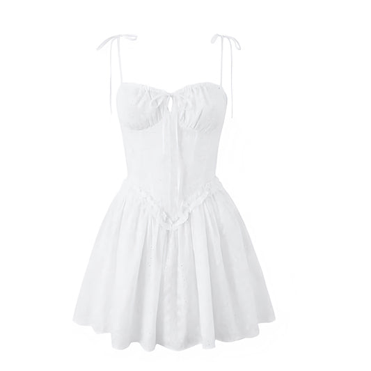 White eyelet floral embroidery milkmaid mini dress with slim fit corset bustier top, drop waist design, sweetheart neckline, ruffle trim details, sleeveless spaghetti straps, and backless flared pleated skirt. Feminine chic coquette summer sundress for women and teens. Perfect for vacation, brunch, beach, sorority rush, school, prom, hoco, homecoming, graduation, parties, night out, going out, Hamptons and Nantucket style. Ships worldwide to USA, UK, Canada, Australia, New Zealand, Germany, France, Ireland