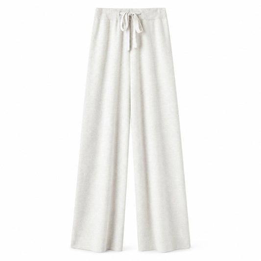 Cream white ivory off-white knit wide leg fleece pants for women with soft sweater-knit construction, ribbed fitted drawstring mid-rise waistband, relaxed baggy fit and full-length draped wide legs. Warm cozy elevated loungewear and knit trousers for fall winter 2026, winter white, clean girl, minimalist, quiet luxury, old money, Scandi, Stockholm, Copenhagen, Parisian, preppy, casual chic, airport, travel, college and everyday outfits.

