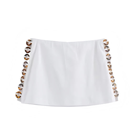 White slim fit tortoiseshell beaded hollow-out low rise mini skirt with loop circle bead cut-out details. Bodycon pencil silhouette short skirt skort for women and teens. Summer and fall 2025 feminine chic Y2K trendy style. Perfect for holiday, vacation, casual everyday, sorority rush, sexy night out, evening party, going out, club wear, rave, festival, concert, Ibiza style, boho chic, bohemian euro summer fashion, coastal granddaughter style, it girl, that girl, resort wear, beach club, Hamptons style