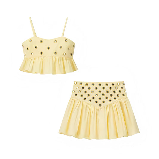 Yellow gold metallic mirror beaded patterned slim fit a-line flared ruffle trim drop waist plissé pleated short mini skirt dress set with spaghetti strap sleeveless backless crop top, matching top and bottoms outfit for women and teens, trendy boho chic feminine fashion, Euro summer Ibiza style, sexy club wear, party, vacation, holiday, beach, concert, festival night out 2025 with global shipping to USA, UK, Europe, Australia, and Canada.